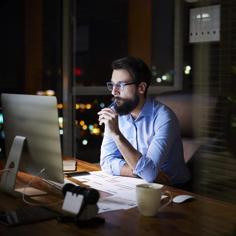Security analyst reviewing systems at night